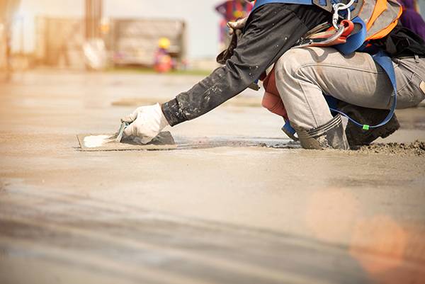 Construction worker Concrete pouring during commercial concreting floors of building in construction site and Civil Engineer